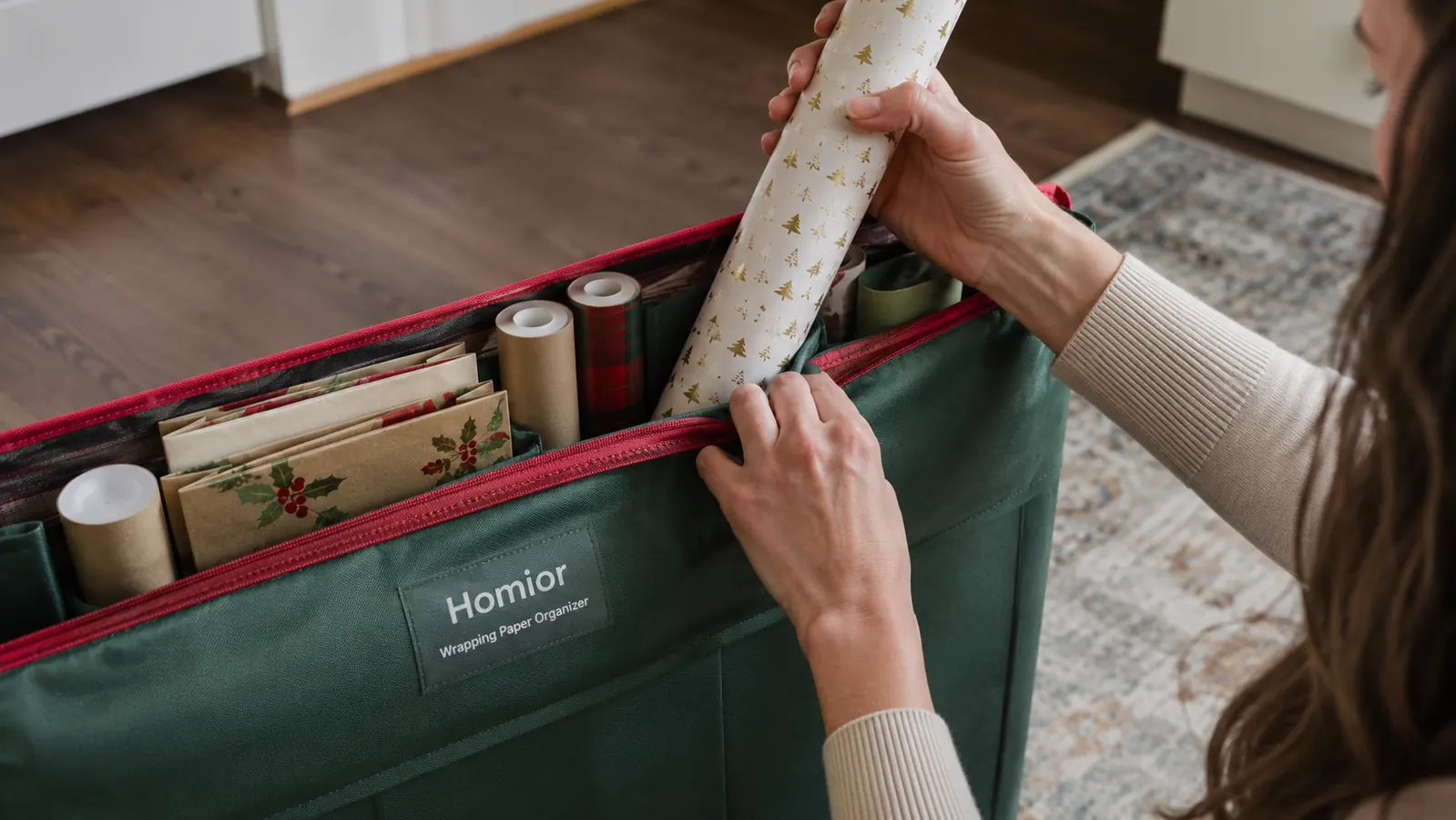 Hand sliding a roll of wrapping paper into a fabric organizer pocket next to a folded gift bag section